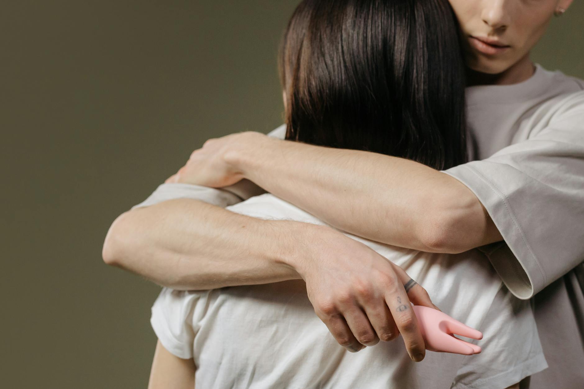 Close-up of a couple embracing, showing tenderness and quiet connection during vulnerable moments.