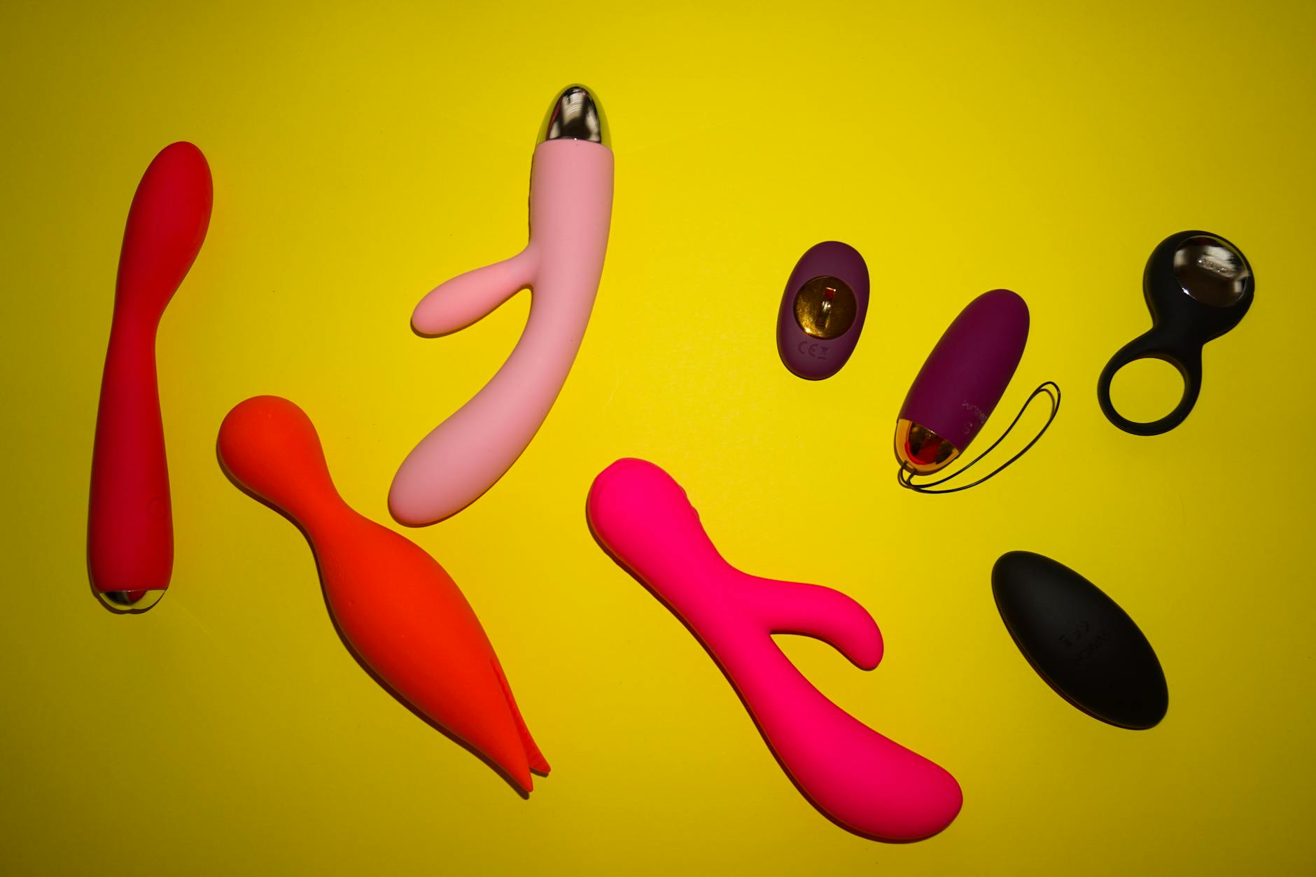 A blue silicone vibrator held in hand against a solid purple background, symbolizing self-care and sexual autonomy