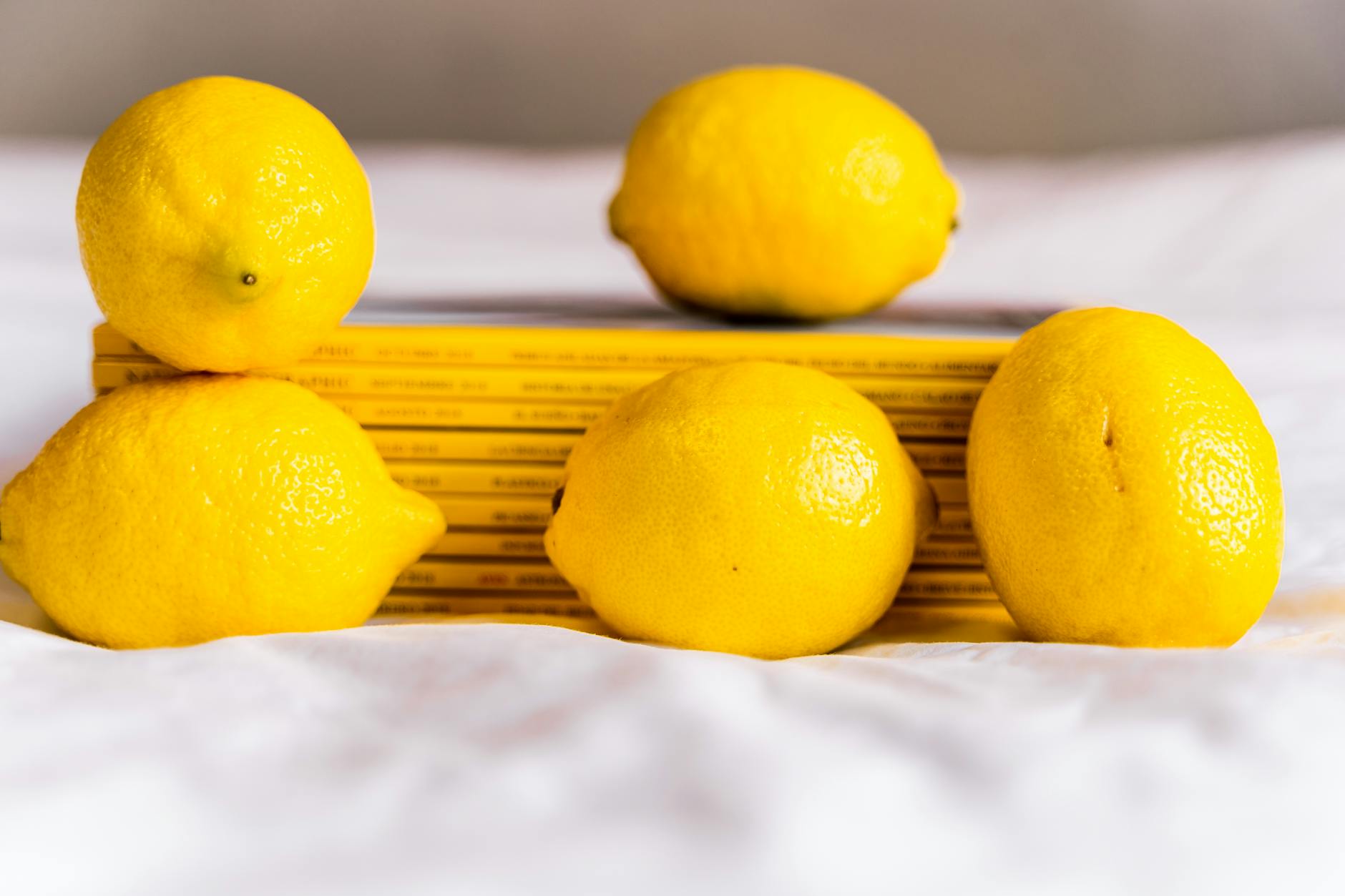 Bright ripe lemons on a yellow background, symbolizing calm and sensory reset
